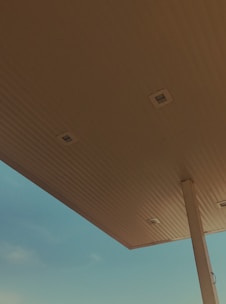 Construction crew working on fuel station canopy installation.