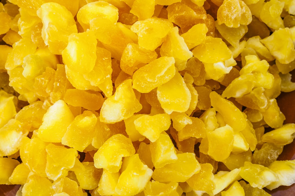 a bowl filled with yellow candies on top of a table