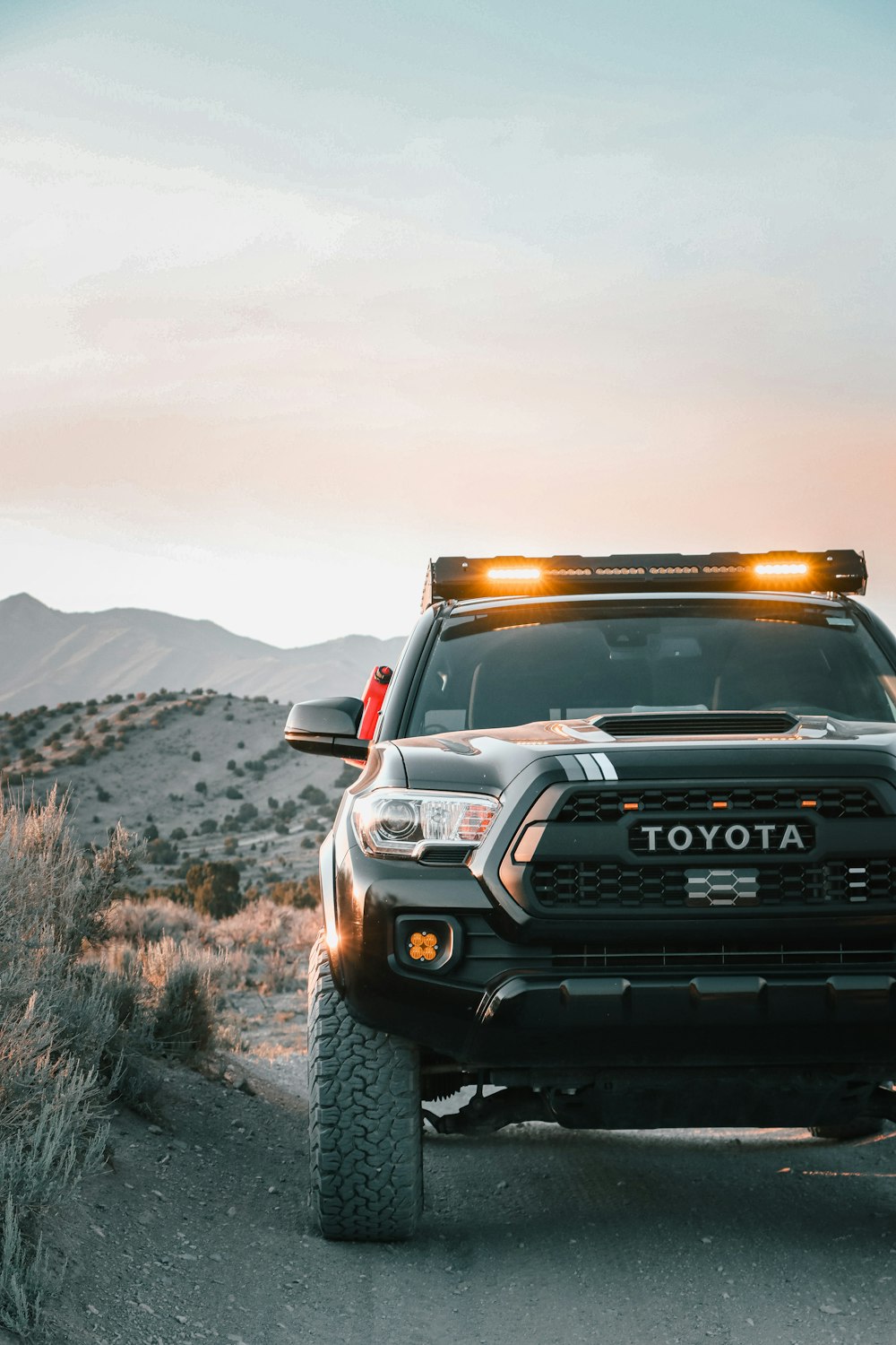 a toyota truck is parked on a dirt road