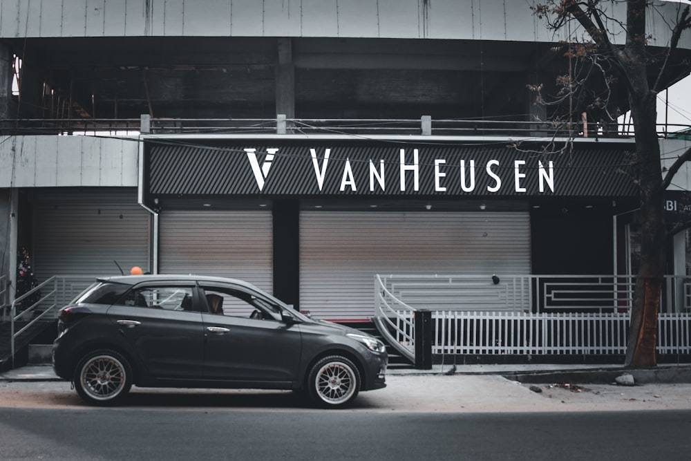 a small car parked in front of a building