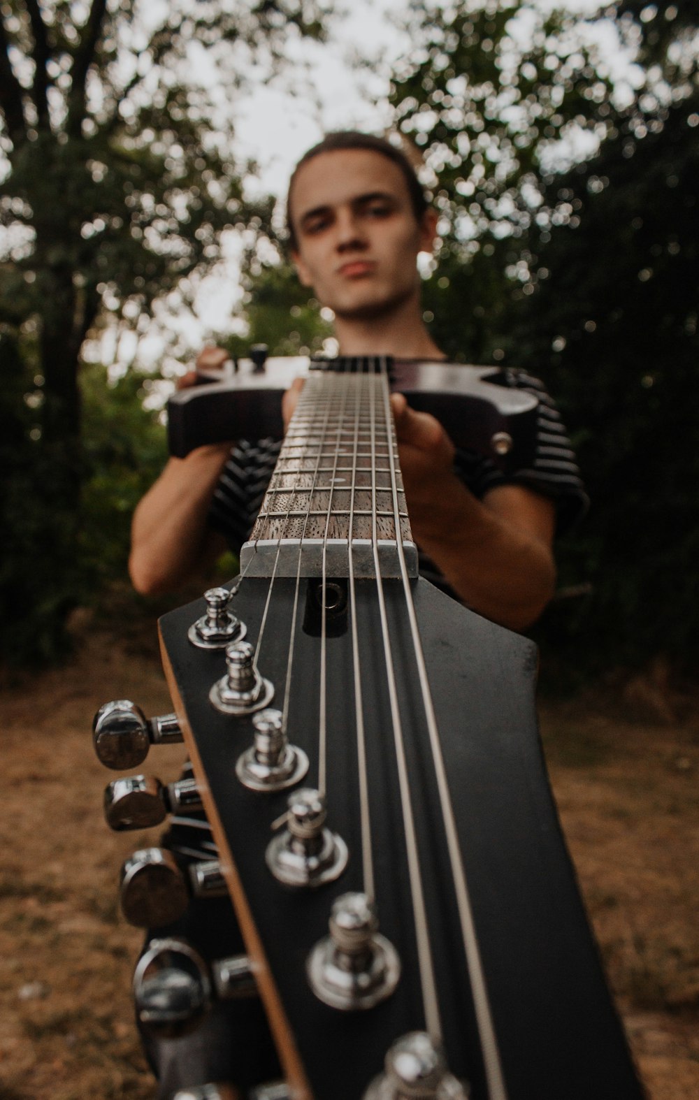 a man holding a guitar in his hands