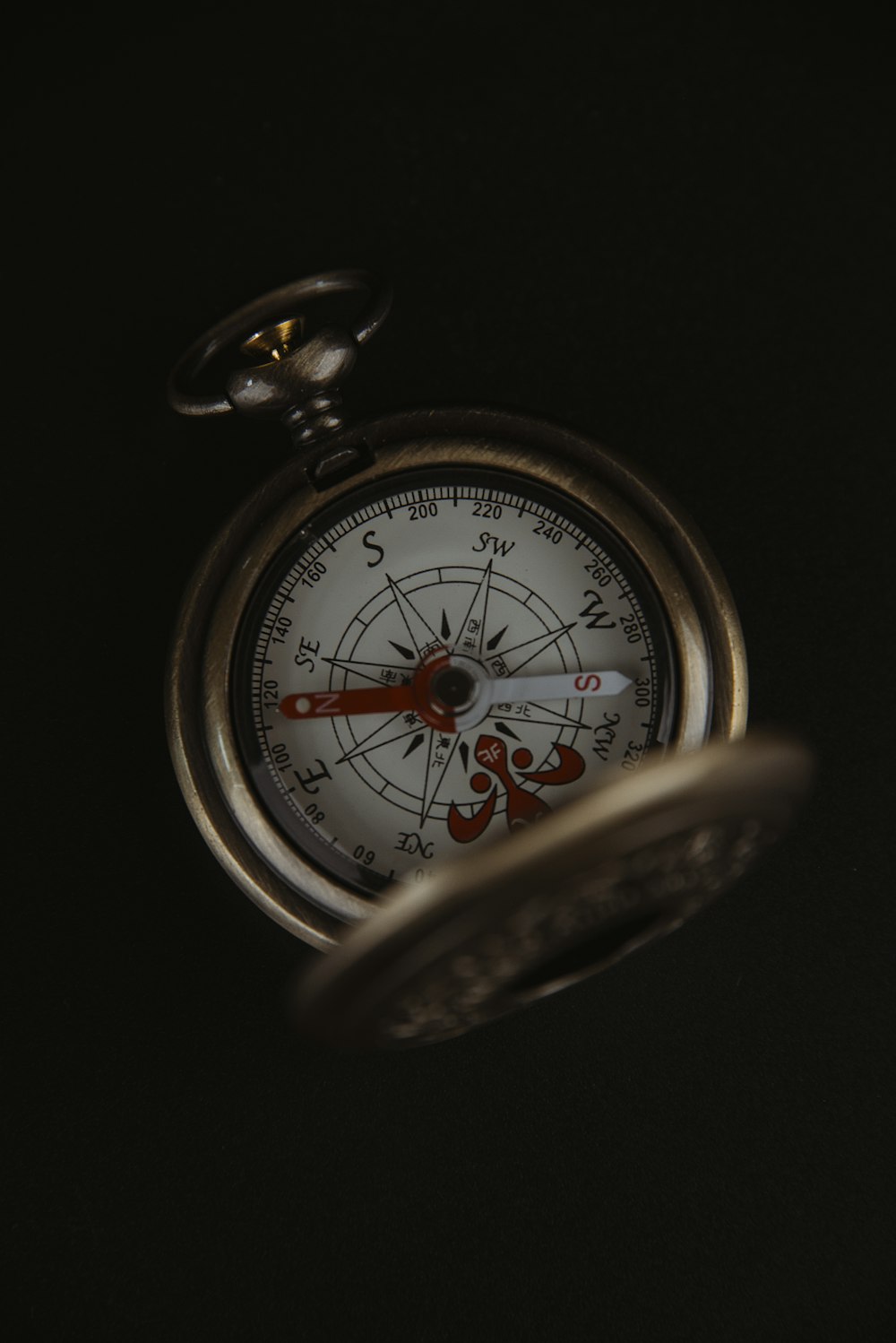a close up of a compass in the dark
