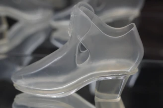 A dustproof shoe rack with a transparent cover keeping shoes clean.
