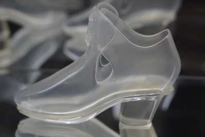 A dustproof shoe rack with a transparent cover keeping shoes clean.