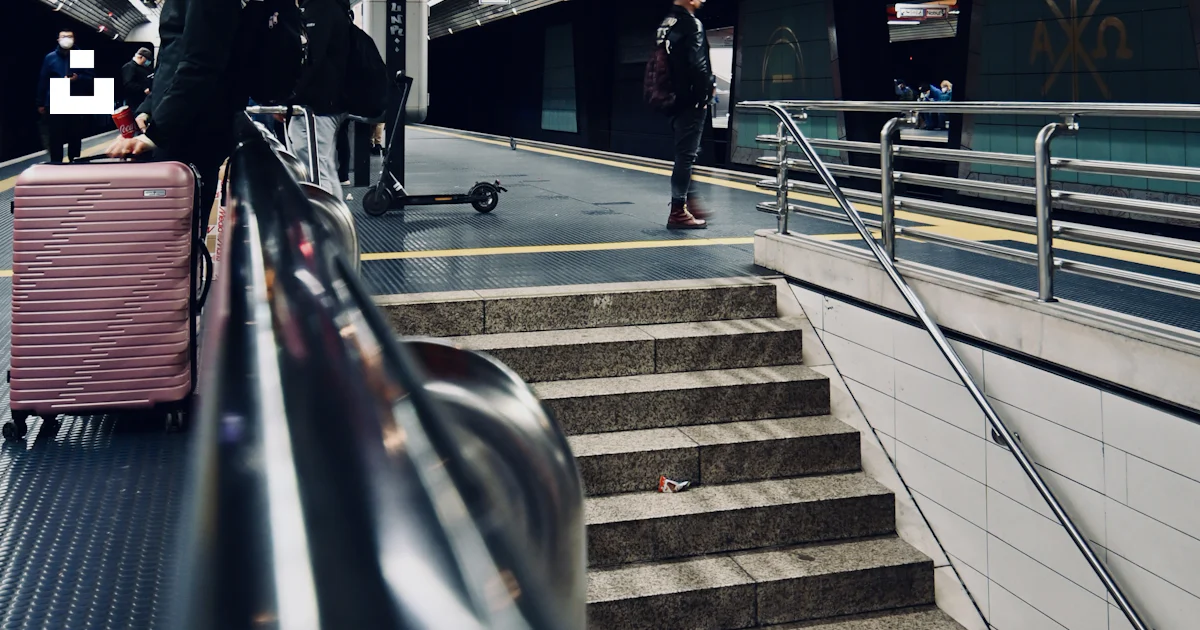 A Person With A Suitcase Walking Down A Set Of Stairs Photo Free a-person-with-a-suitcase-walking-down-a-set-of-stairs-photo-free