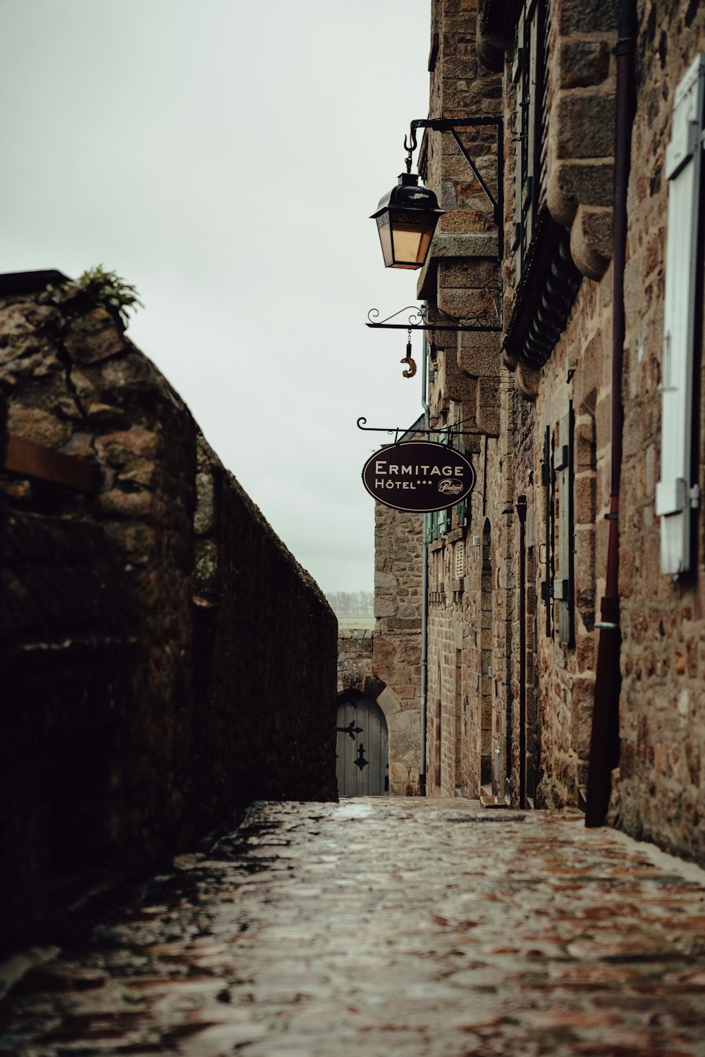 a cobblestone street lined with stone buildings