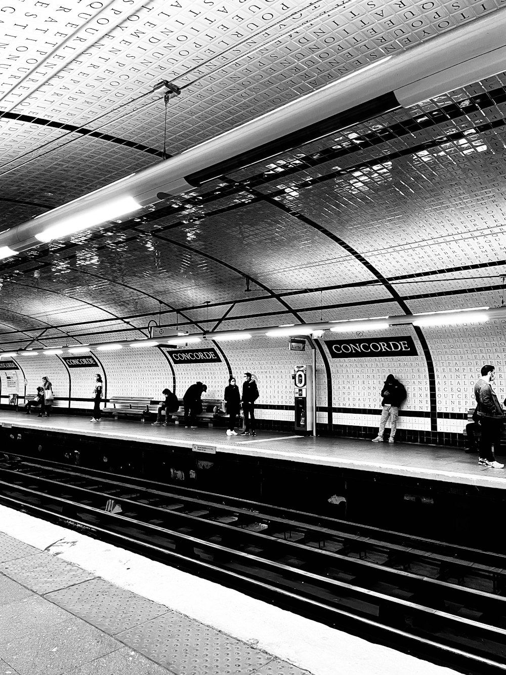 a black and white photo of a subway station
