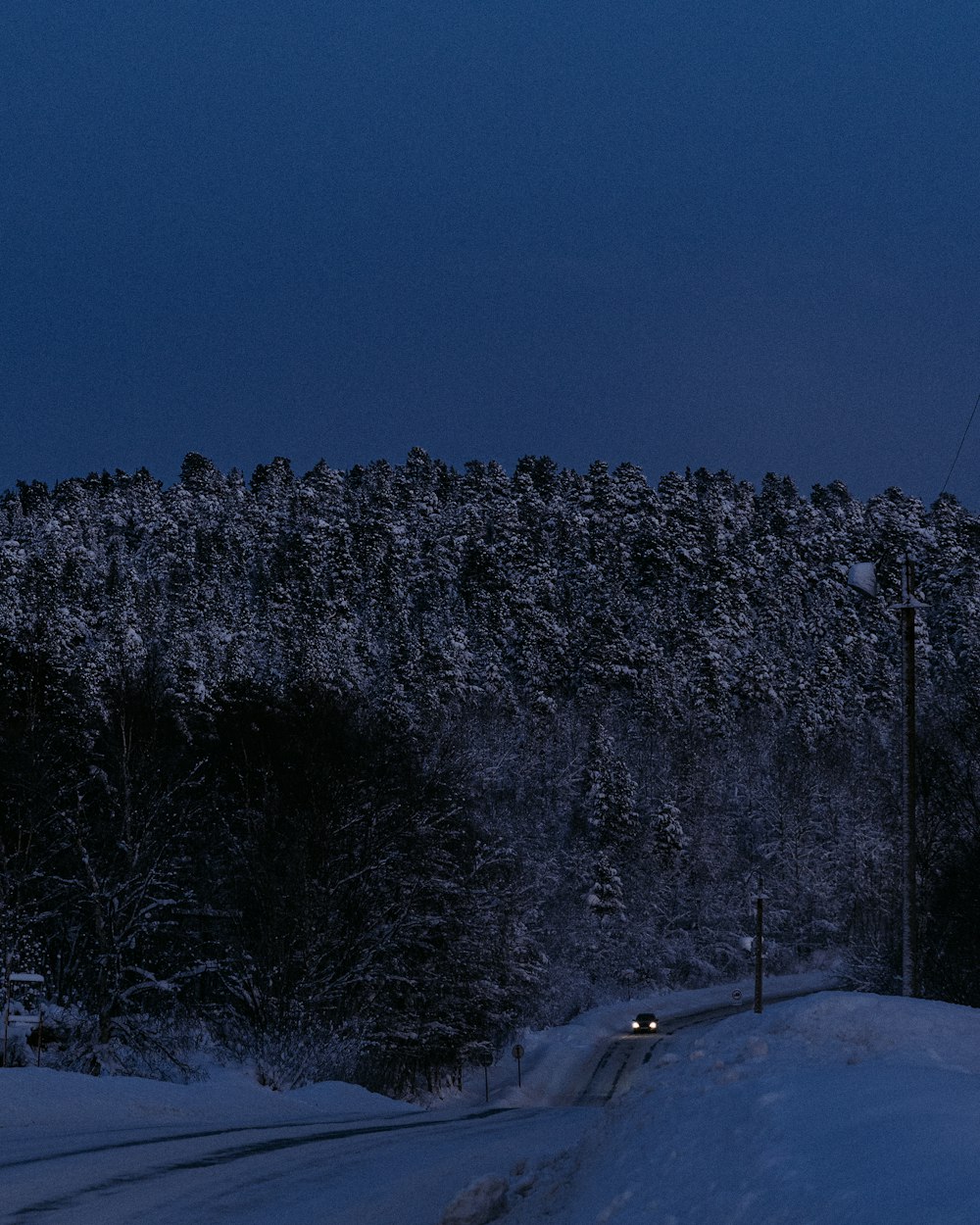 a man riding a snowboard down a snow covered slope