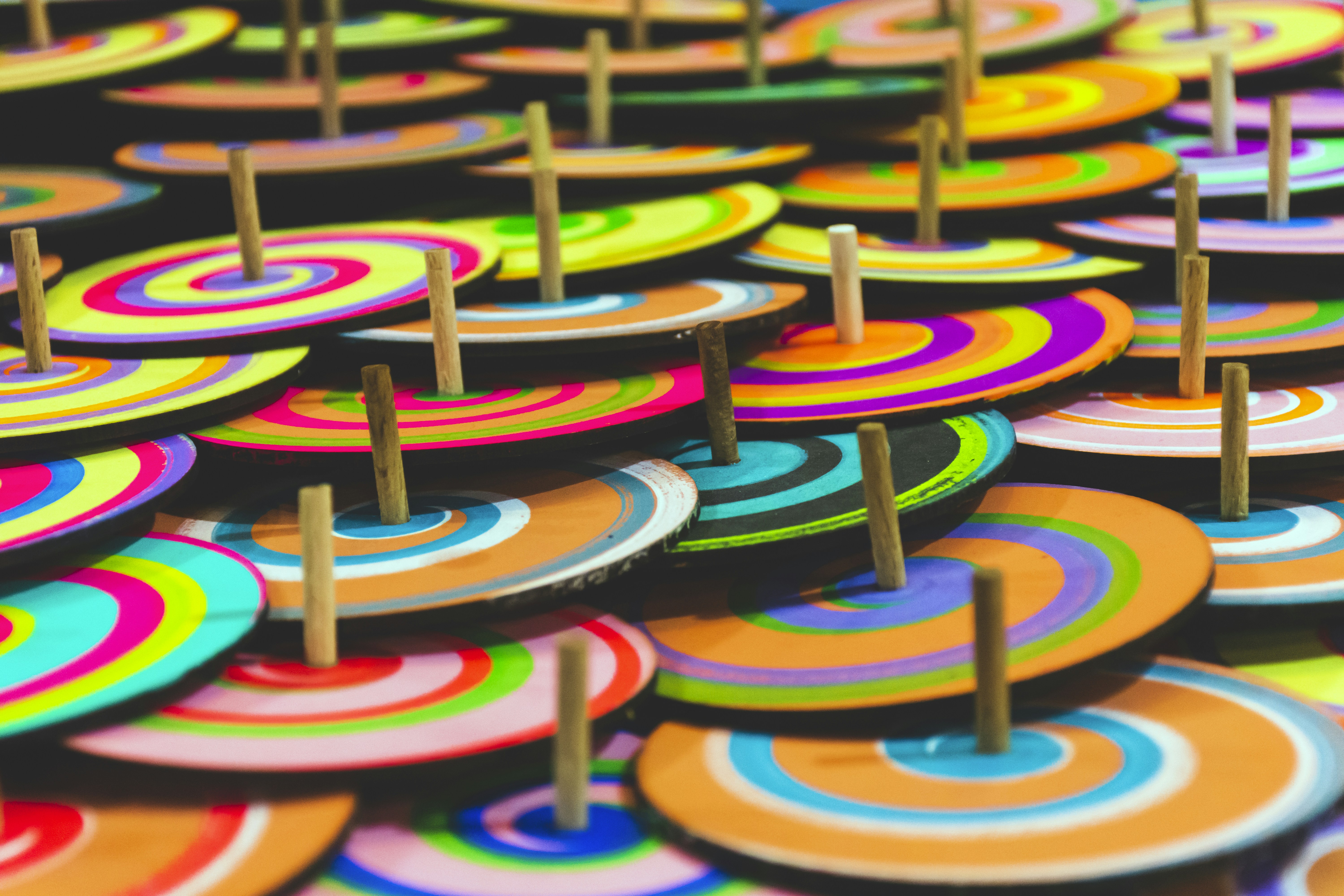 a group of colorful umbrellas with wooden sticks sticking out of them