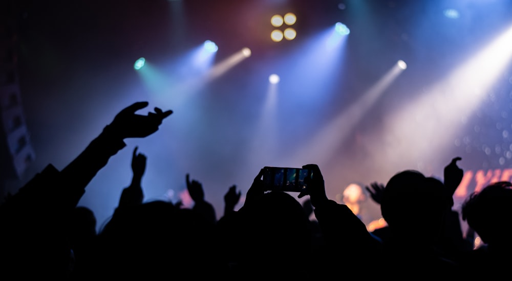 a crowd of people standing on top of a stage