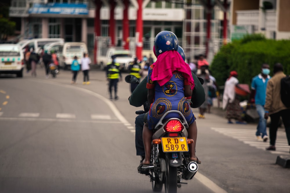 a person riding a motorcycle down a street