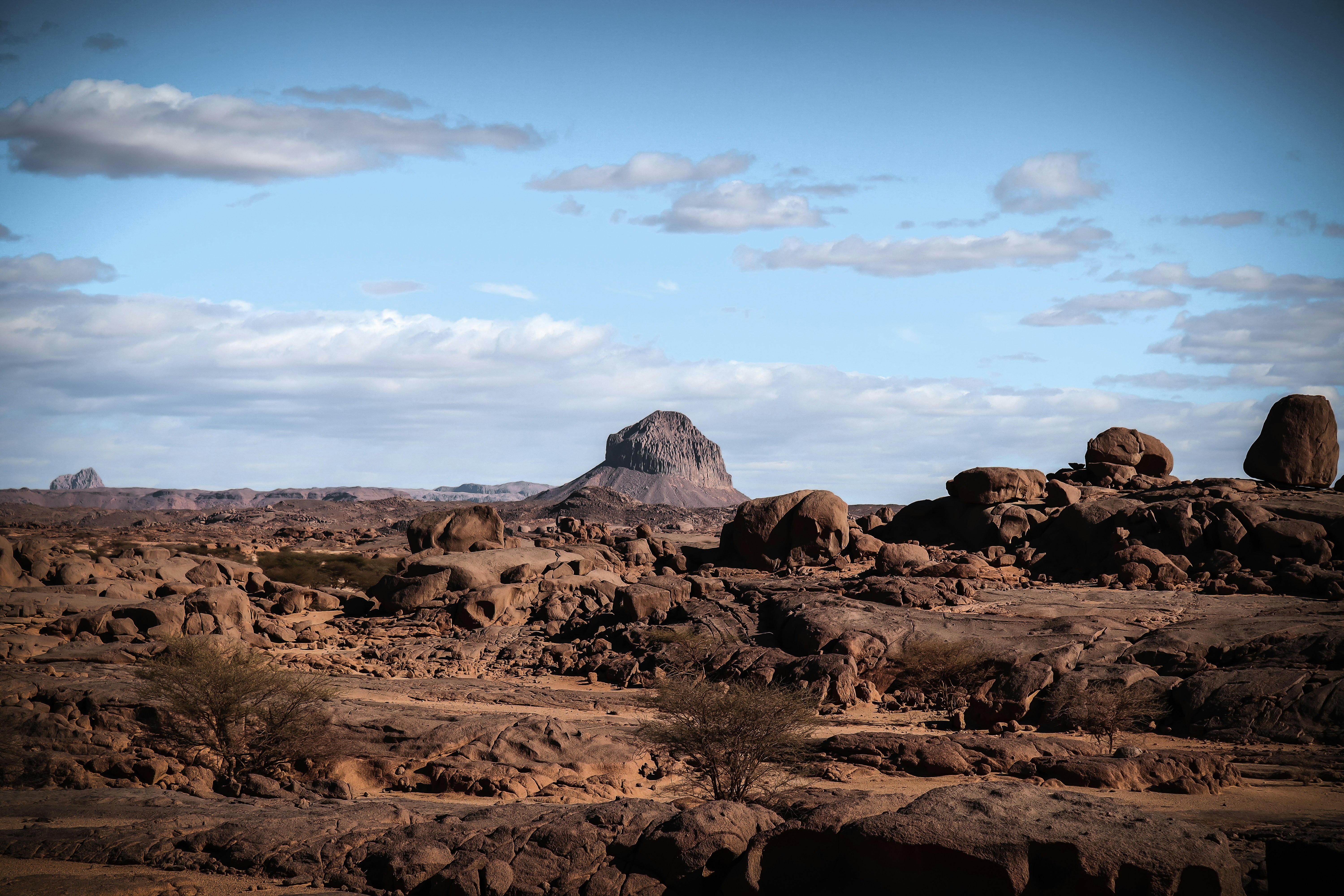 a large rock formation in the middle of a desert