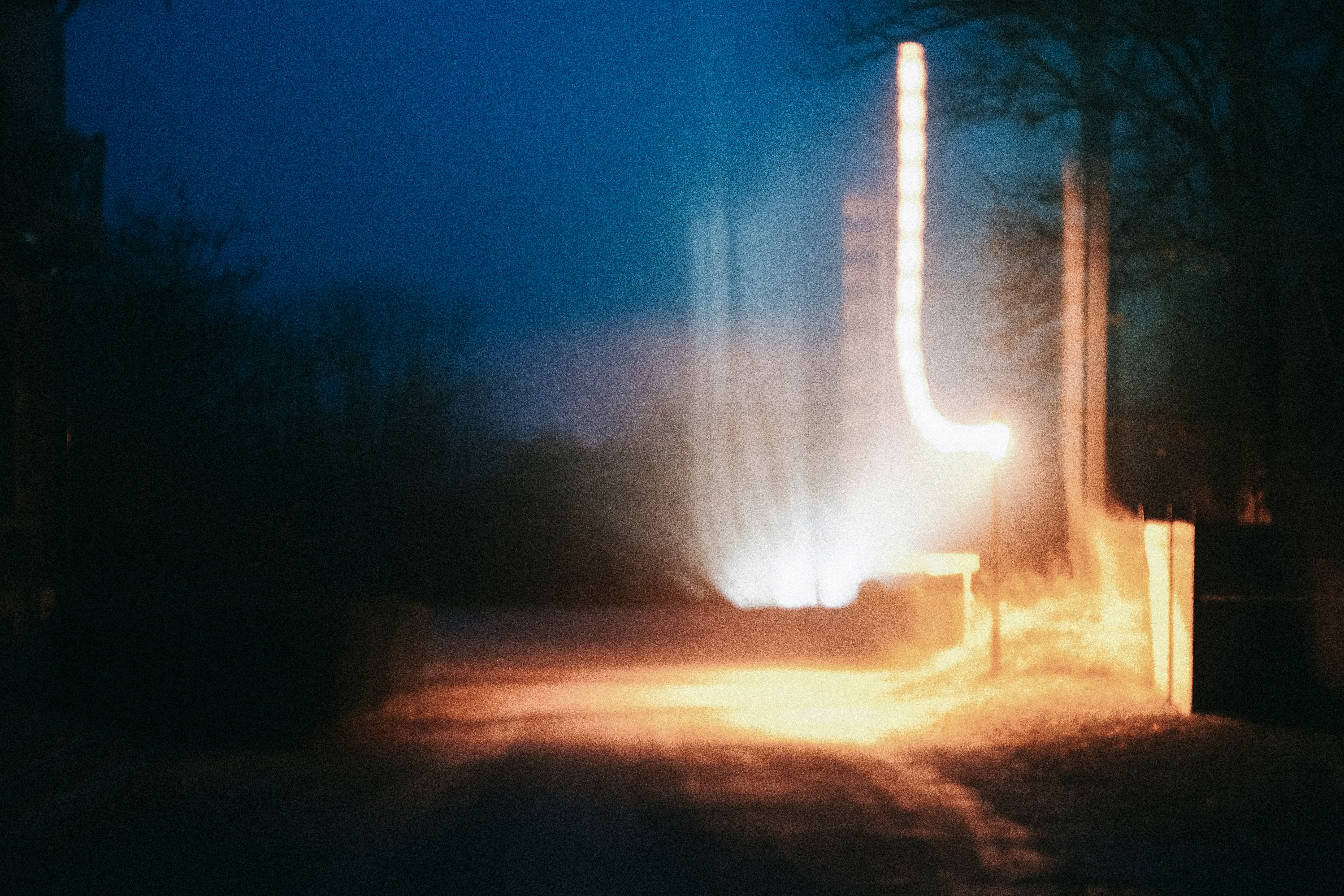 a blurry photo of a street at night