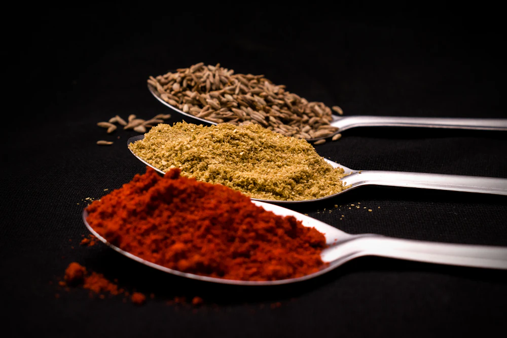 Dehydrated spice powders on steel spoons