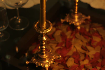 Elegant brass candle holders arranged on a polished marble table.
