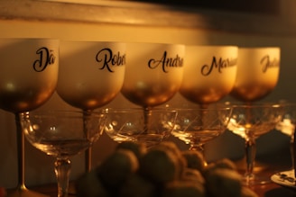 a row of wine glasses sitting on top of a table