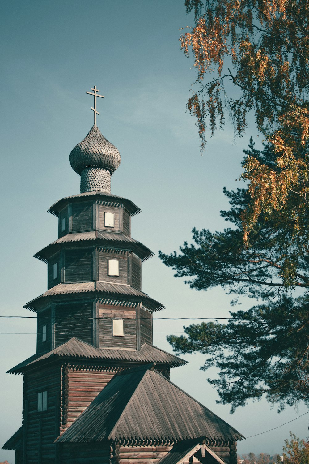 a wooden church with a cross on top of it
