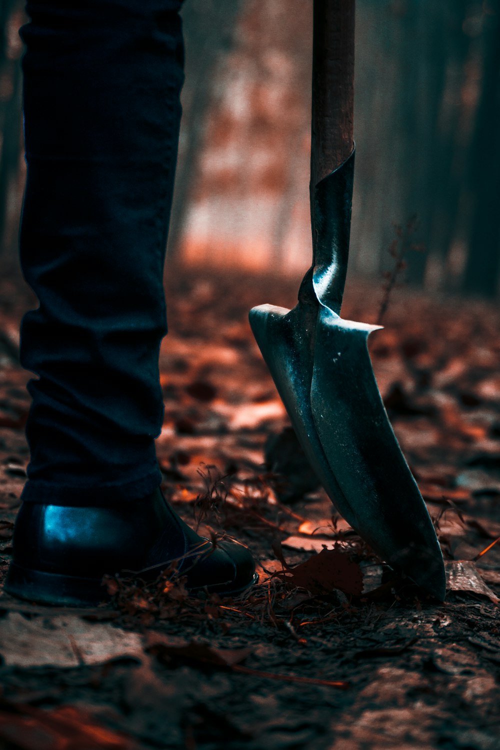 a person standing in the woods holding a knife