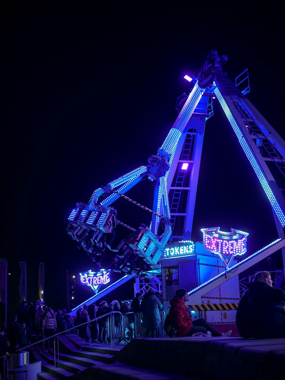 a ferris wheel lit up at night at an amusement park