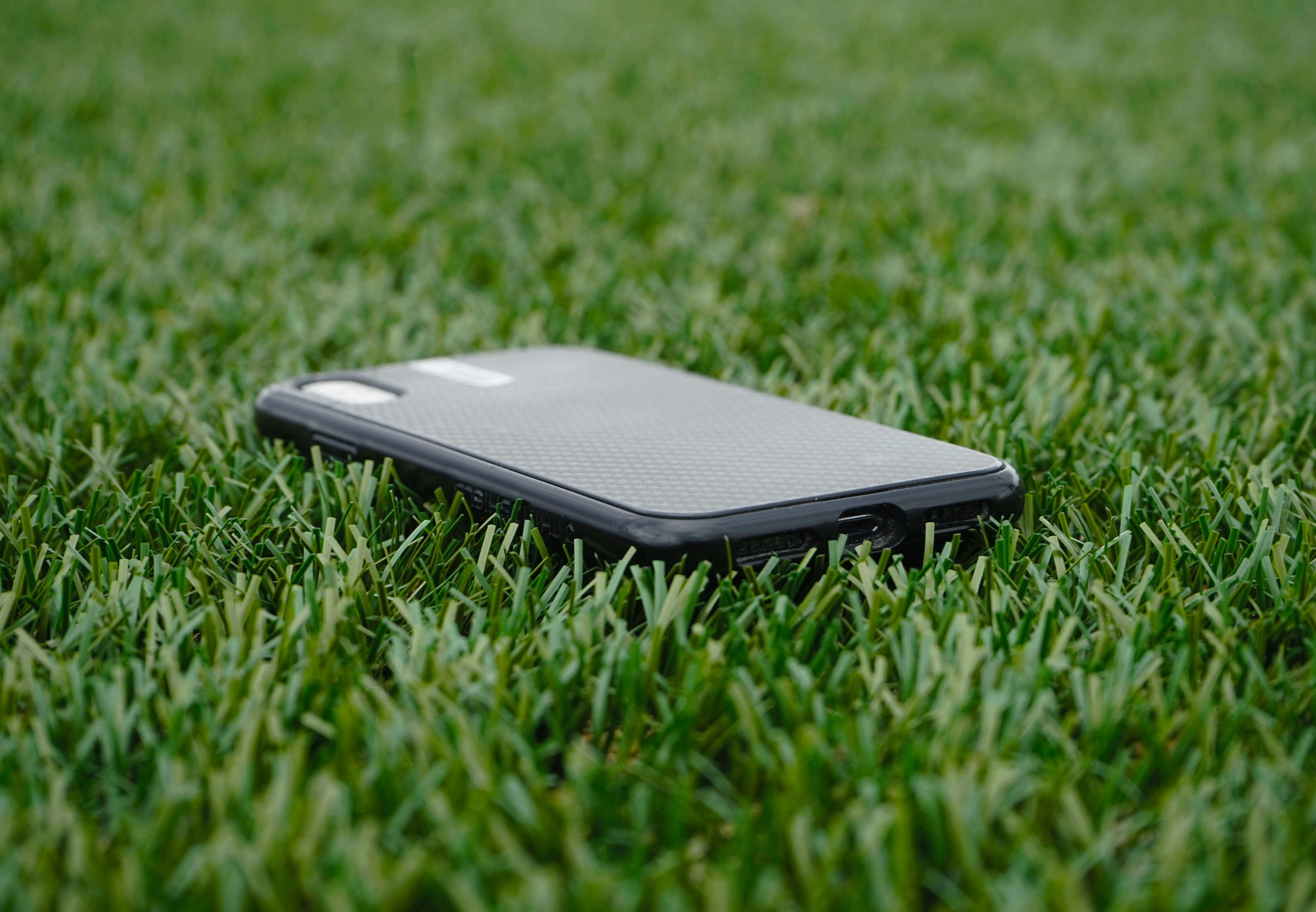a close up of a cell phone in the grass