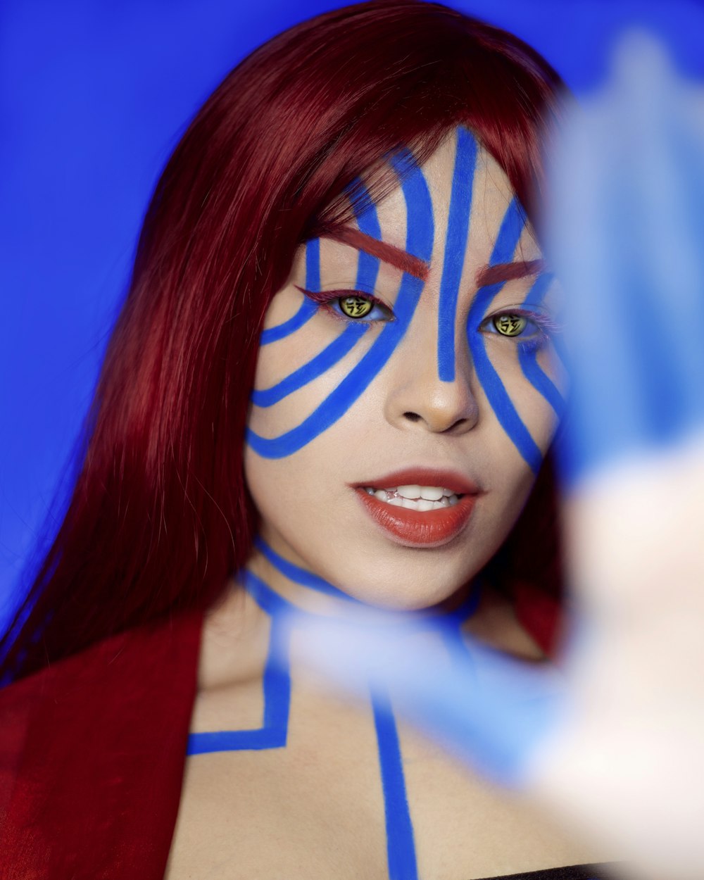 a woman with blue lines painted on her face