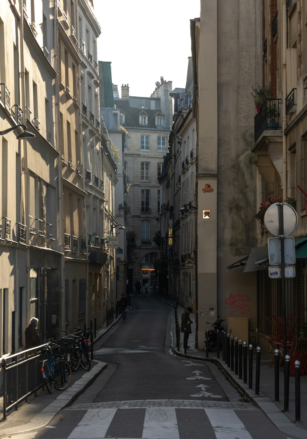 a narrow city street lined with tall buildings