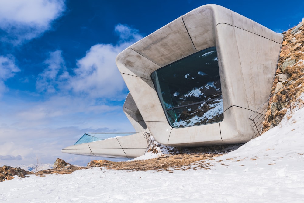 a concrete structure sitting on top of a snow covered slope
