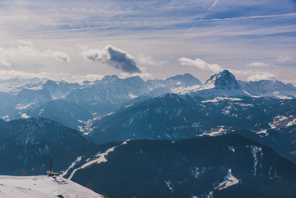 a view of a mountain range with a ski lift in the foreground