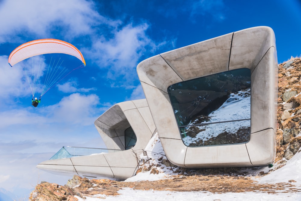 a person parasailing over a snow covered mountain