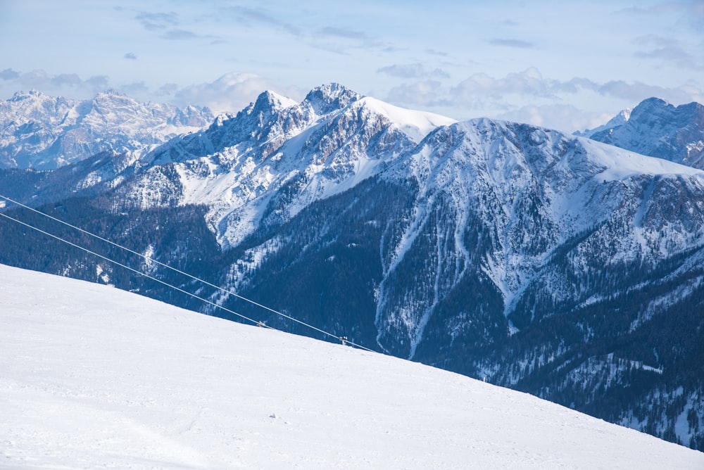 a man riding a snowboard down the side of a snow covered slope