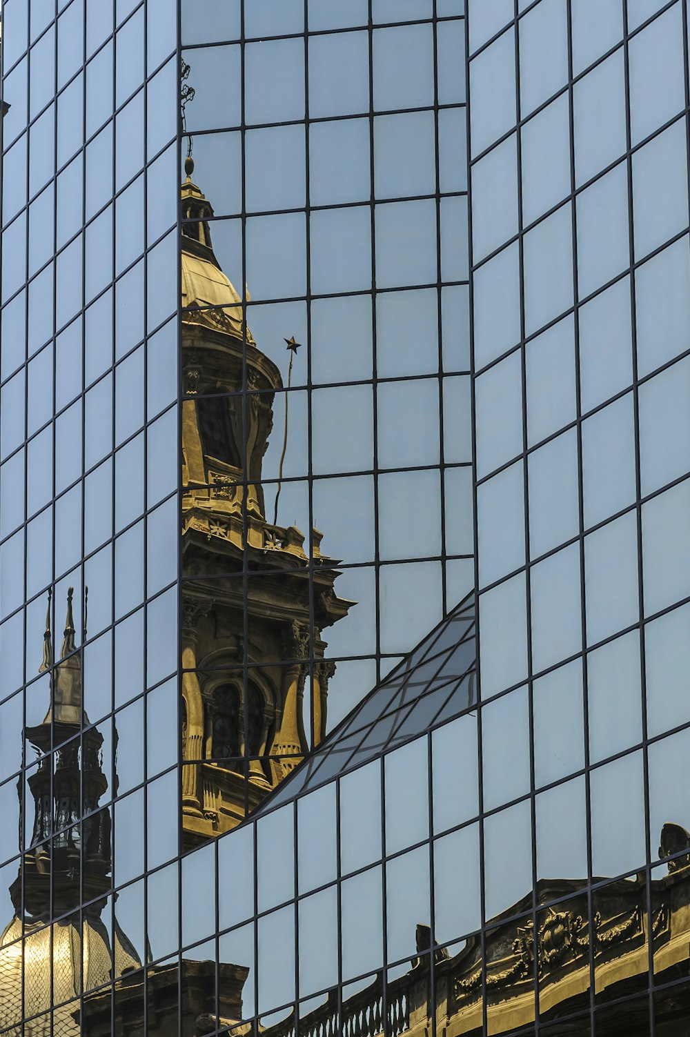 a reflection of a building in a glass window