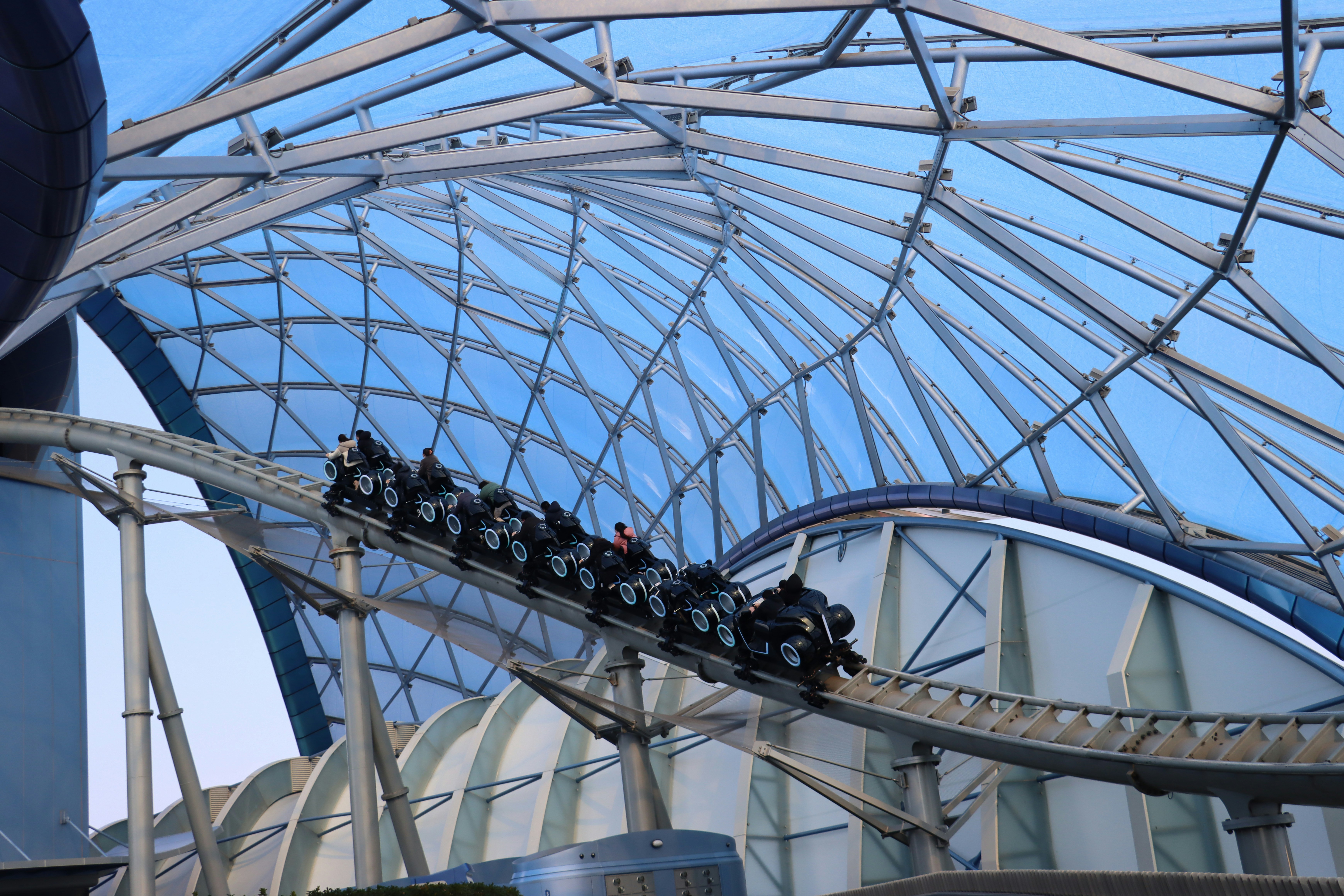 a roller coaster ride in a building with a sky background, 