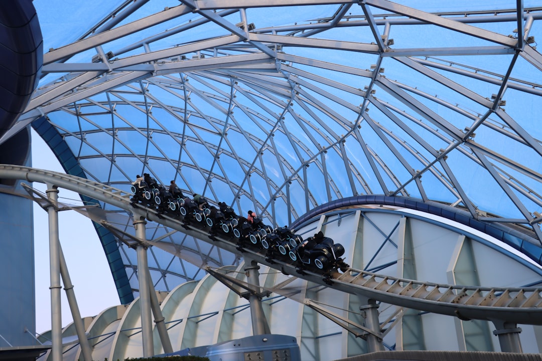 a roller coaster ride in a building with a sky background,