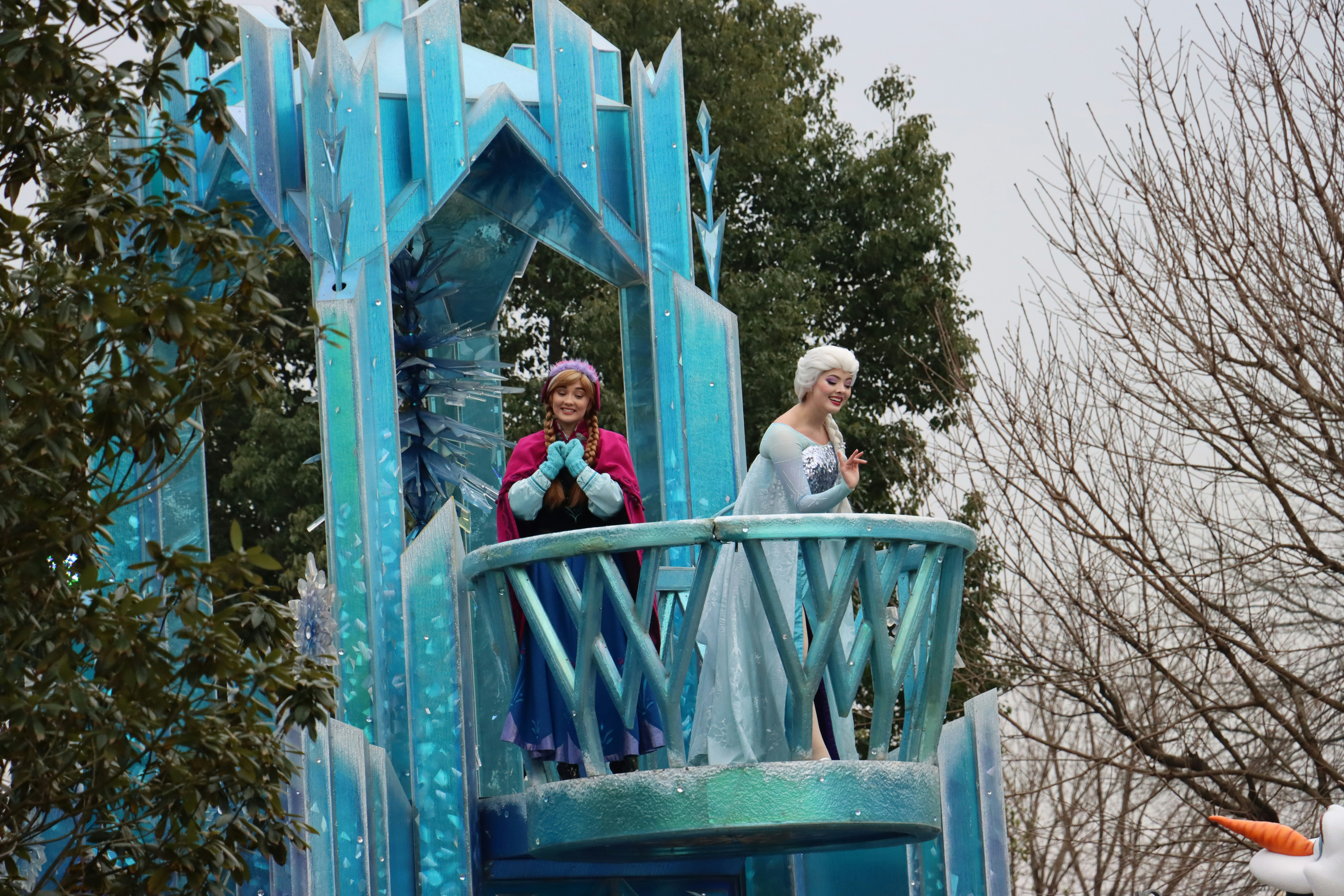a couple of women standing on top of a blue tower