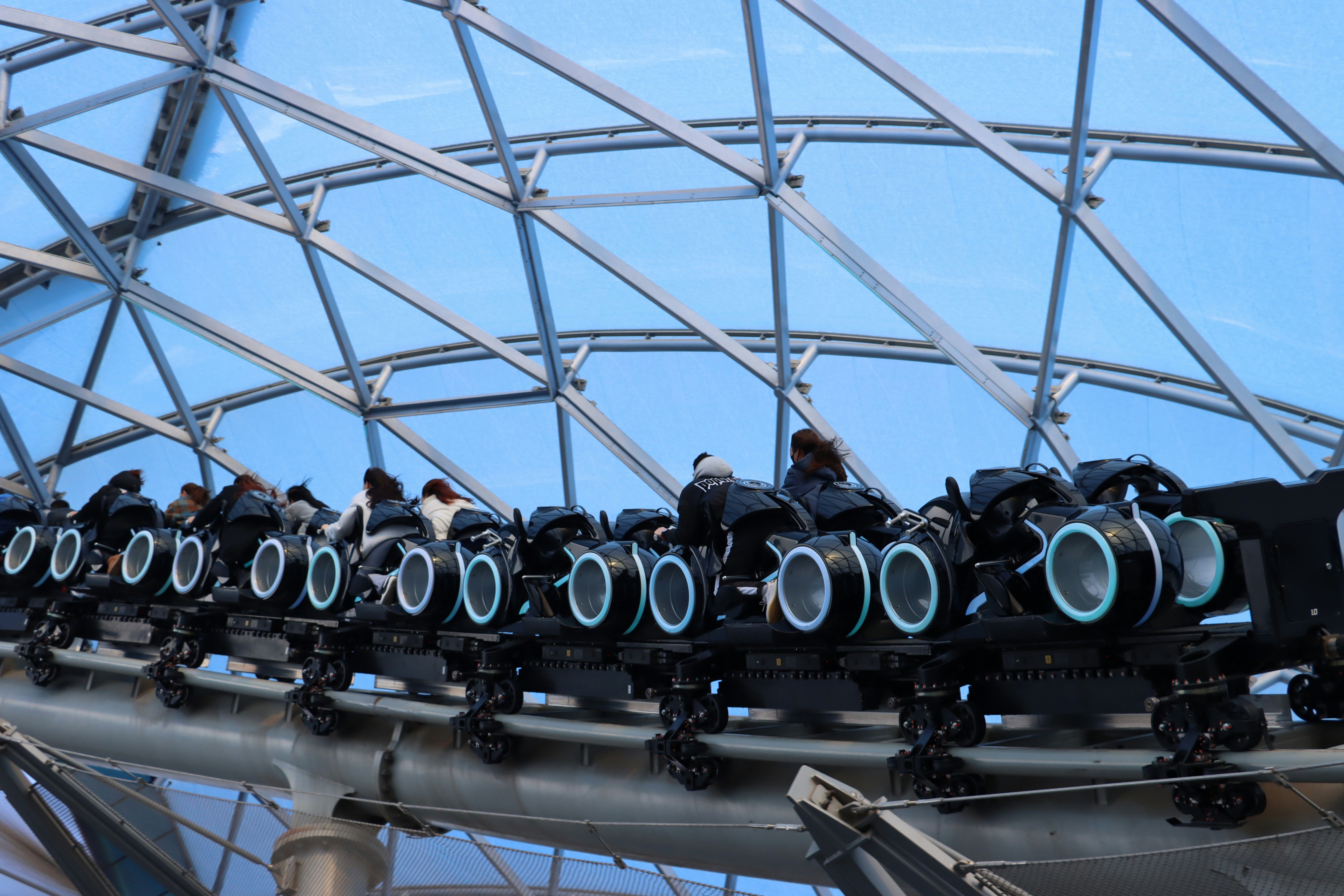 a group of people riding roller coasters on a roller coaster, 