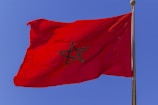 a red flag with a black star on it