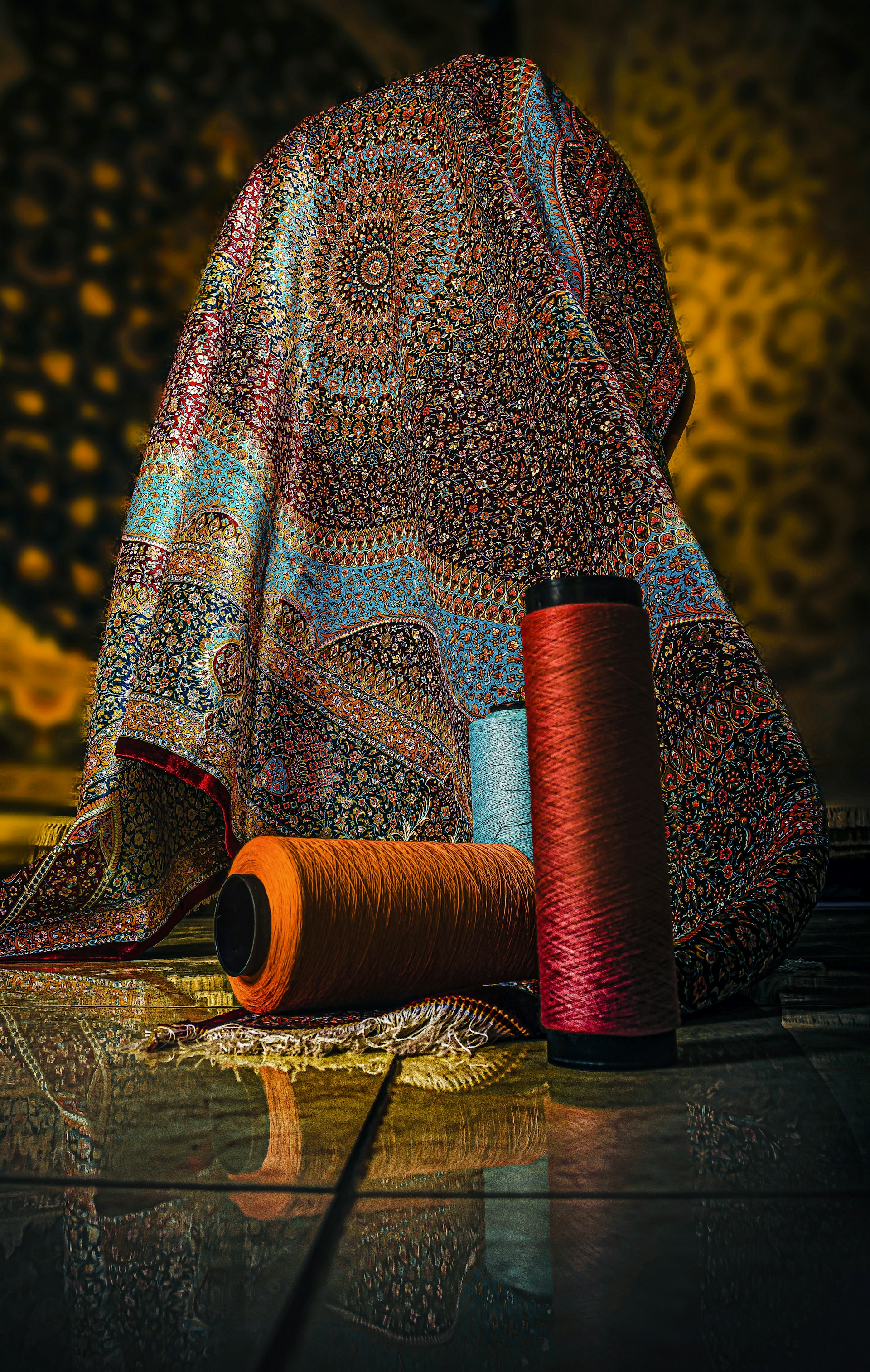a close up of a cloth and a spool of thread