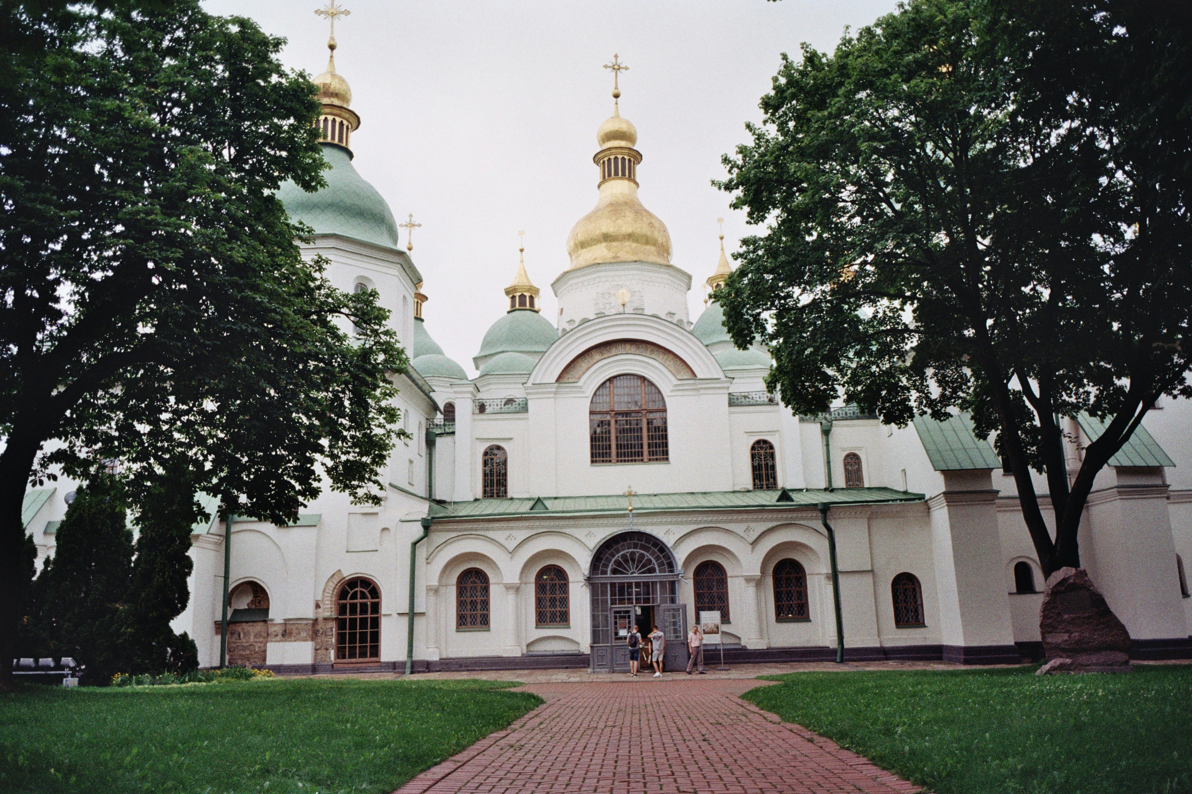 a large white building with gold domes on top of it