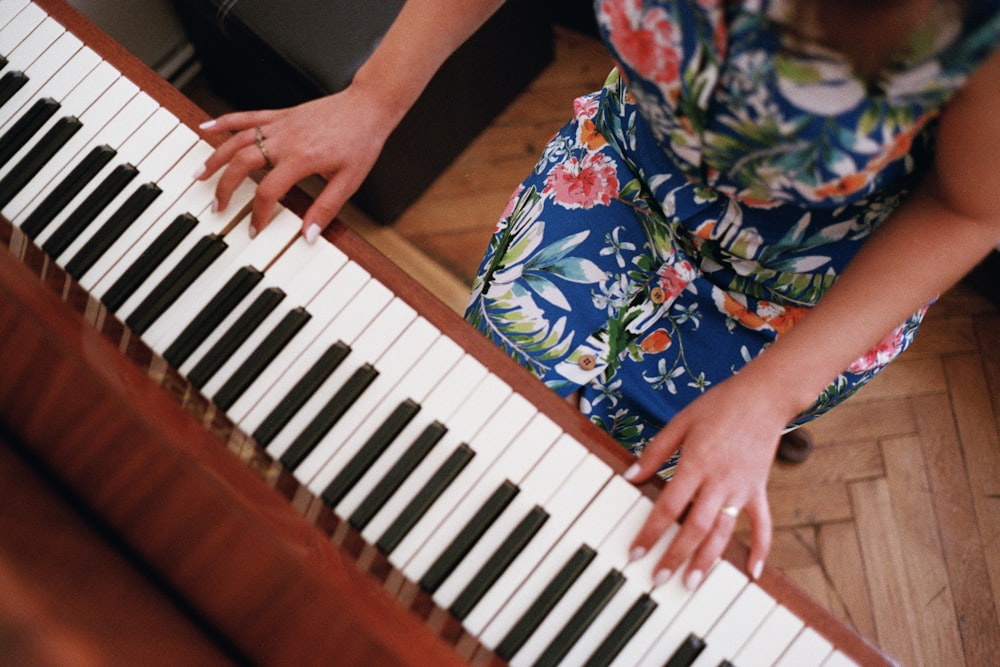 a woman is playing the piano with her hands