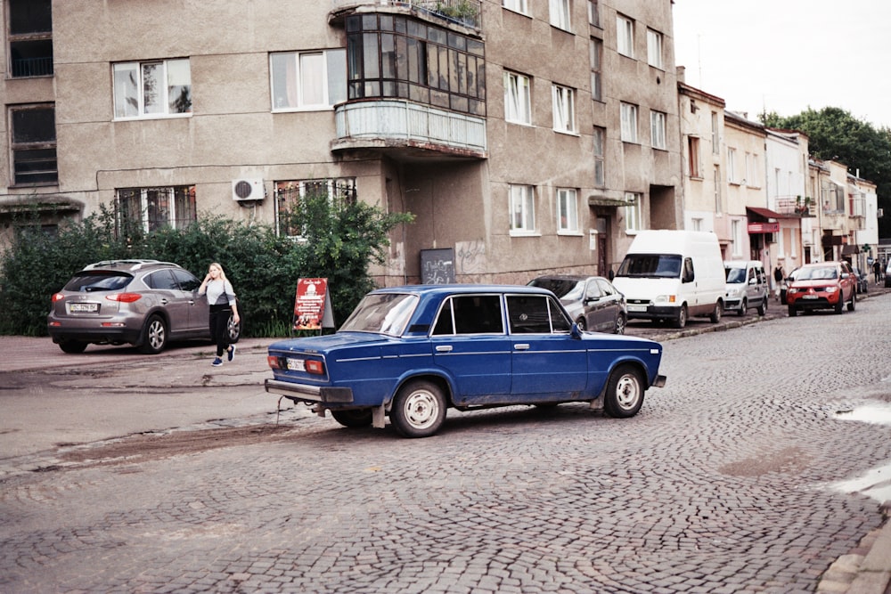 a blue truck parked on the side of a road