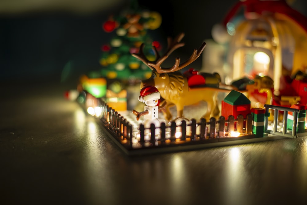 a christmas scene with a reindeer and a house
