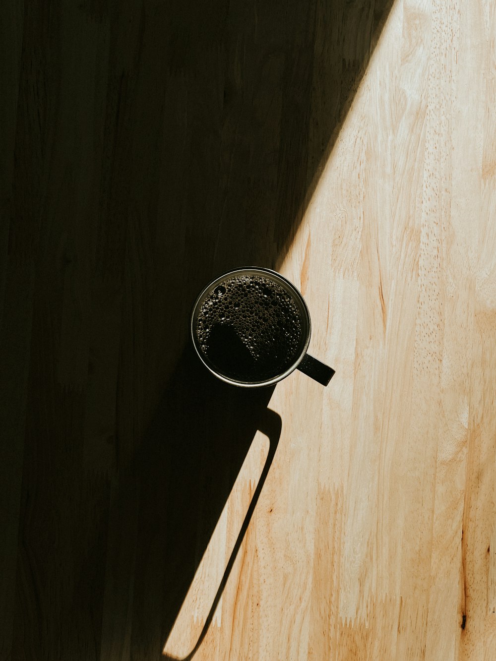 a wooden table with a metal bowl on top of it