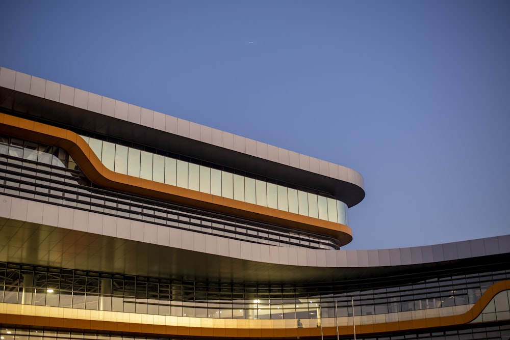 a building with a curved roof and a sky background