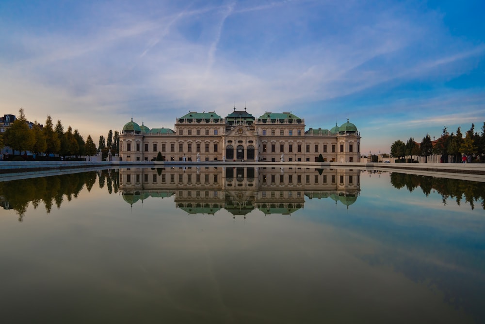 un grande edificio con un grande specchio d'acqua di fronte