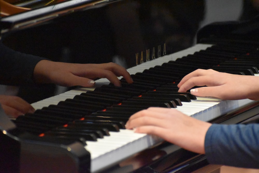 a group of people that are playing a piano