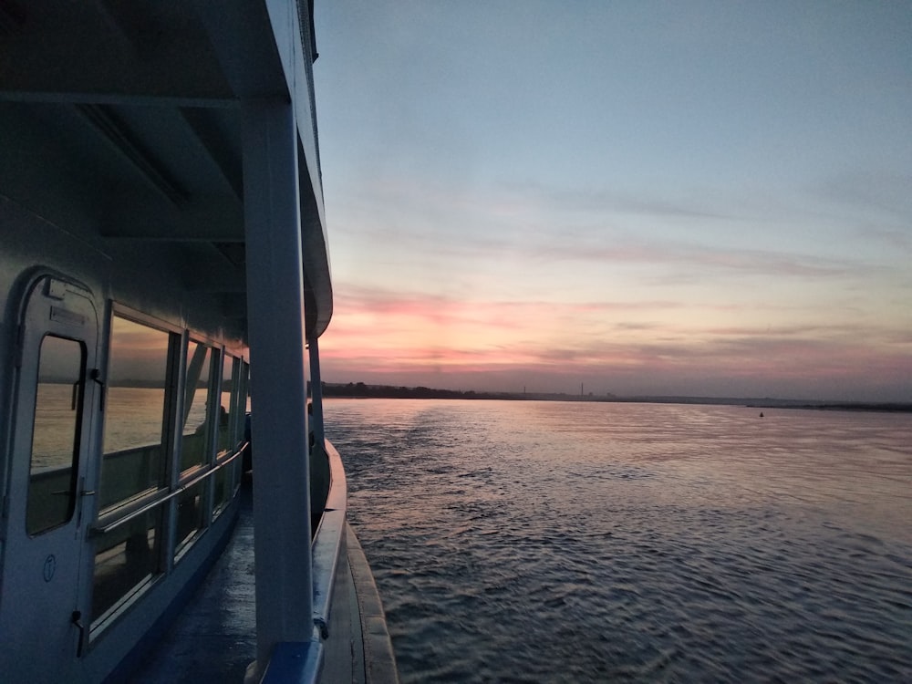 a boat traveling down a river at sunset