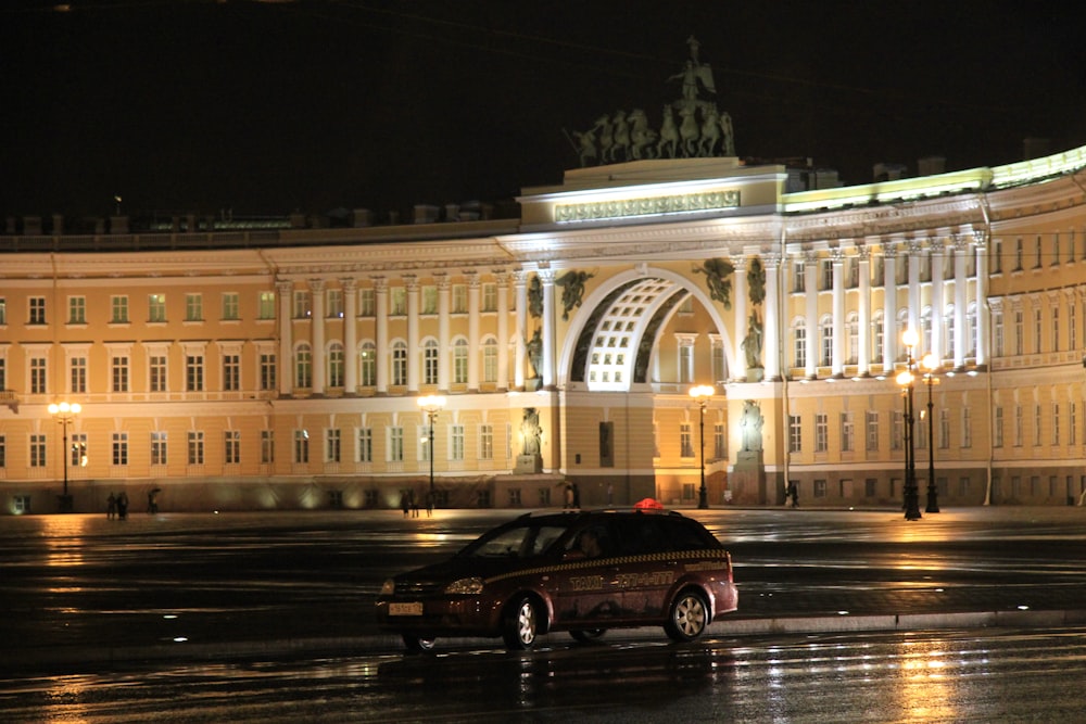 a car parked in front of a large building