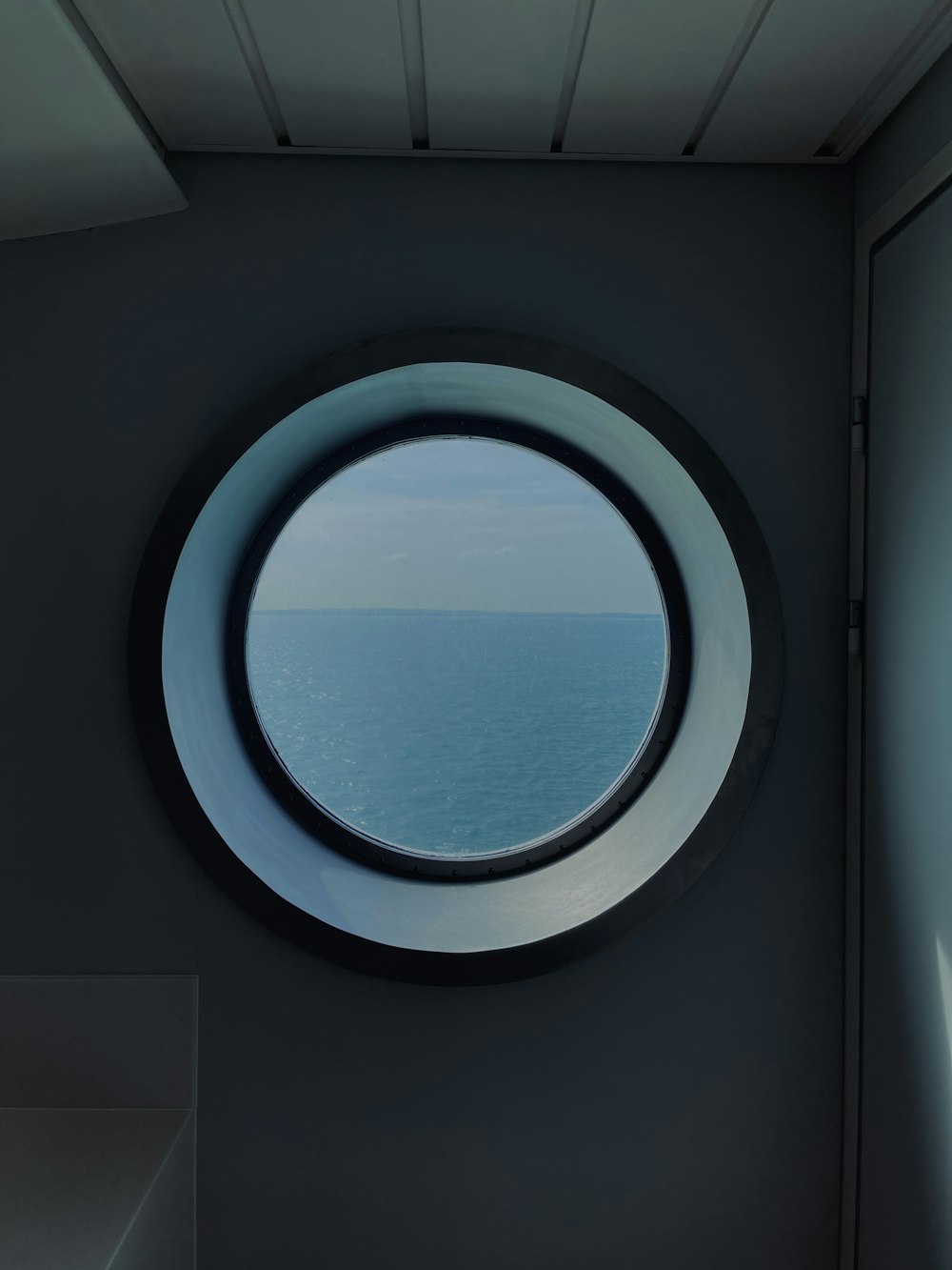 a round window with a view of the ocean