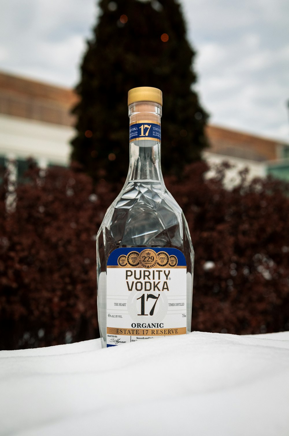 a bottle of whisky sitting on top of a snow covered ground