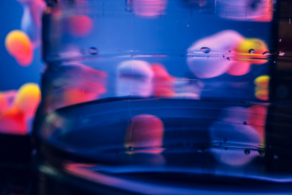 a glass filled with liquid and colorful bubbles